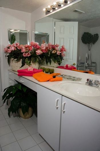 Spacious bathrooms with marble vanities